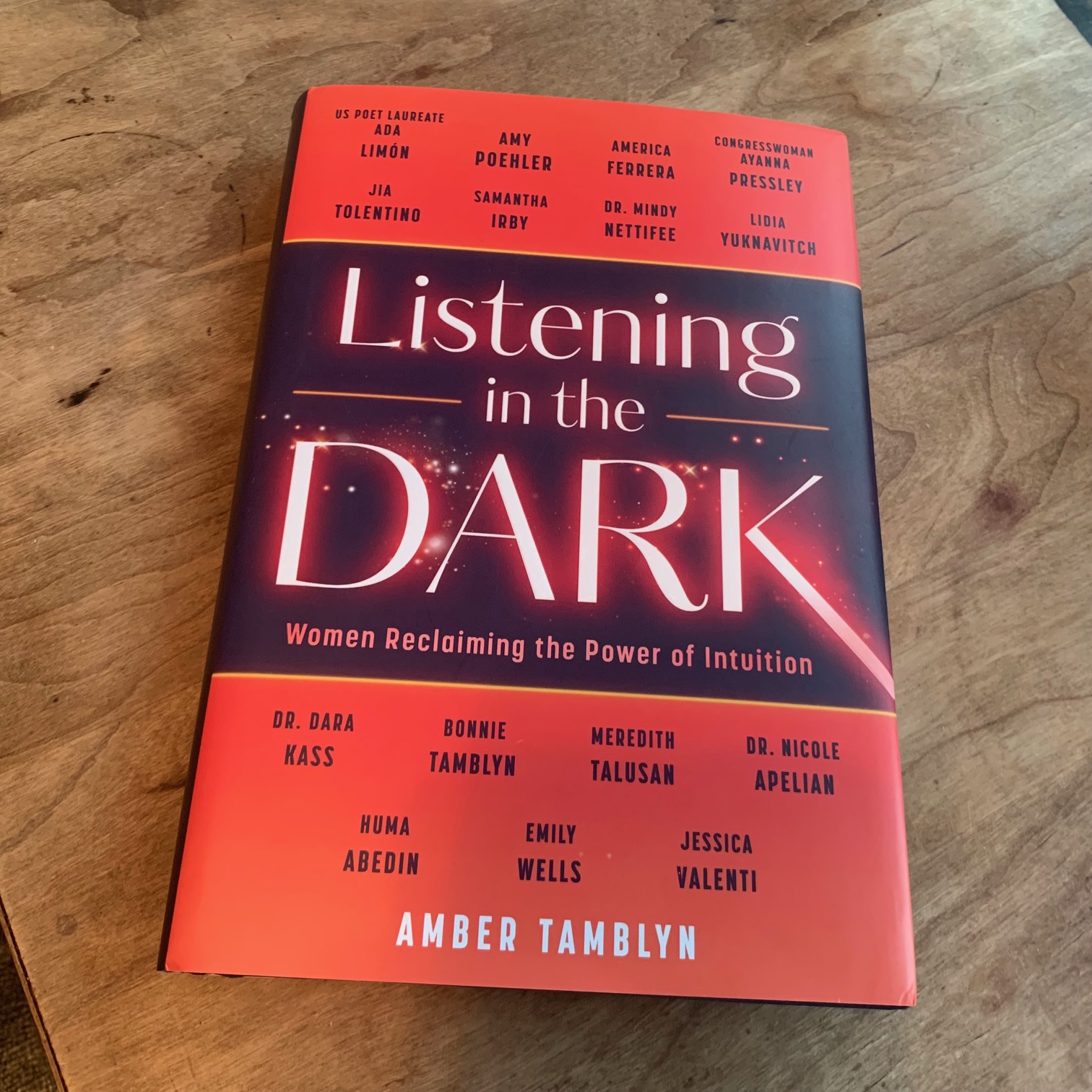 The red and black cover of Listening in the Dark